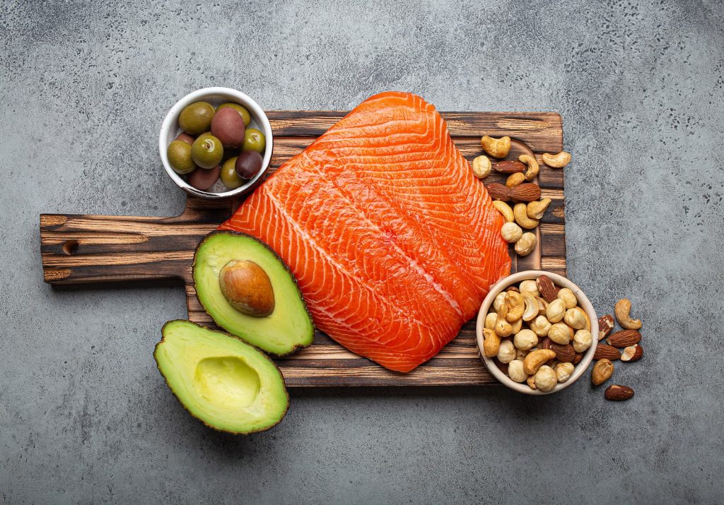 Food sources of healthy unsaturated fat: fresh raw salmon fillet, avocado, olives, nuts