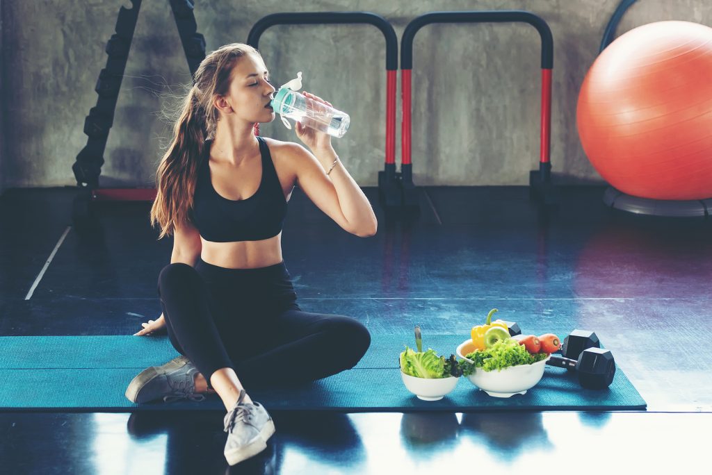 meal prep - woman drink water at fitness gym