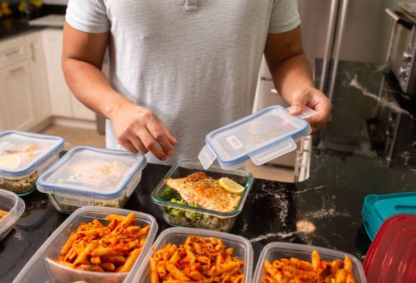 prepared food for bodybuilders - Man putting away meal prep containers