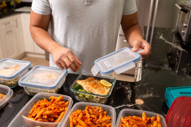 prepared food for bodybuilders - Man putting away meal prep containers